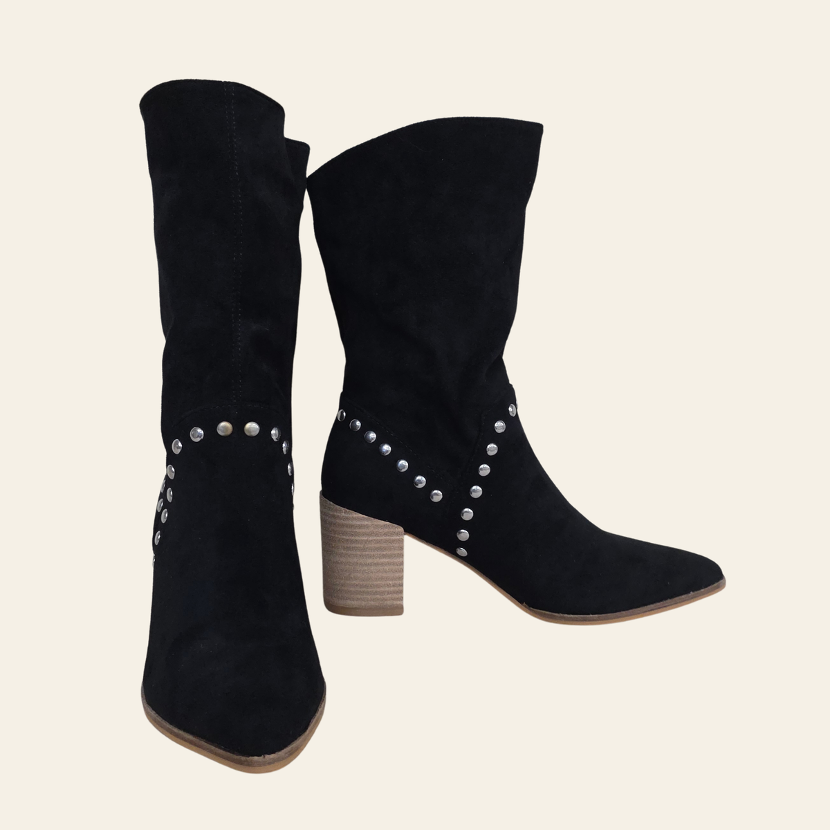 The Brigitta black faux suede slouchy boot that has metal studs, stacked heel and slip on ease.