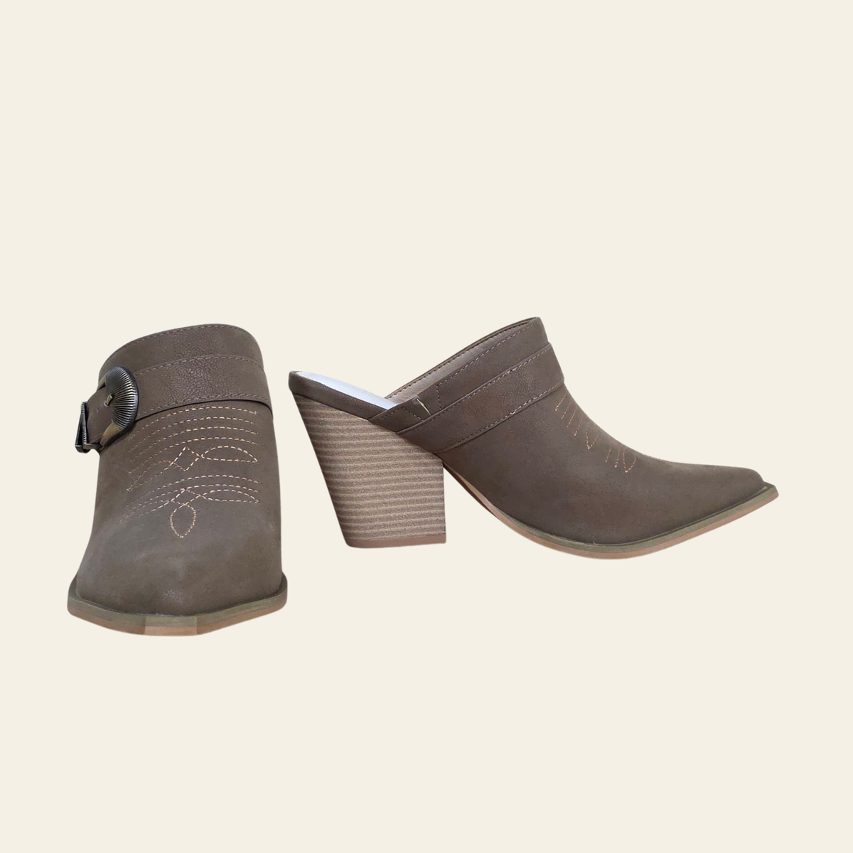 A pair of women's pointed-toe mule boots in a taupe-brown suede-like material, featuring a stacked block heel, slingback strap, and decorative contrast stitching on the side.