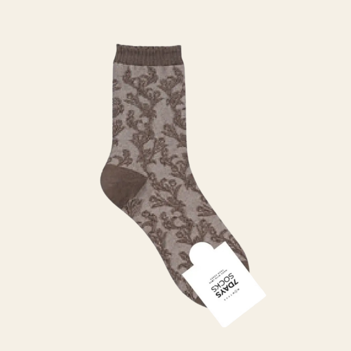 A single ankle-length sock with a brown and taupe damask pattern, shown with its white paper tag attached against a solid cream background.