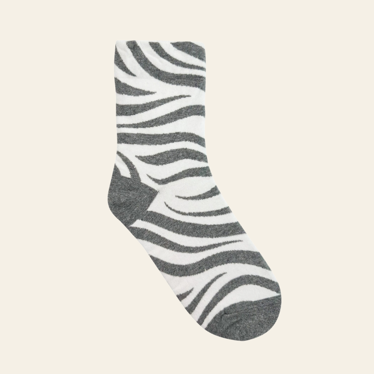 Crew sock with a gray and white zebra stripe pattern, shown against a solid light beige background.