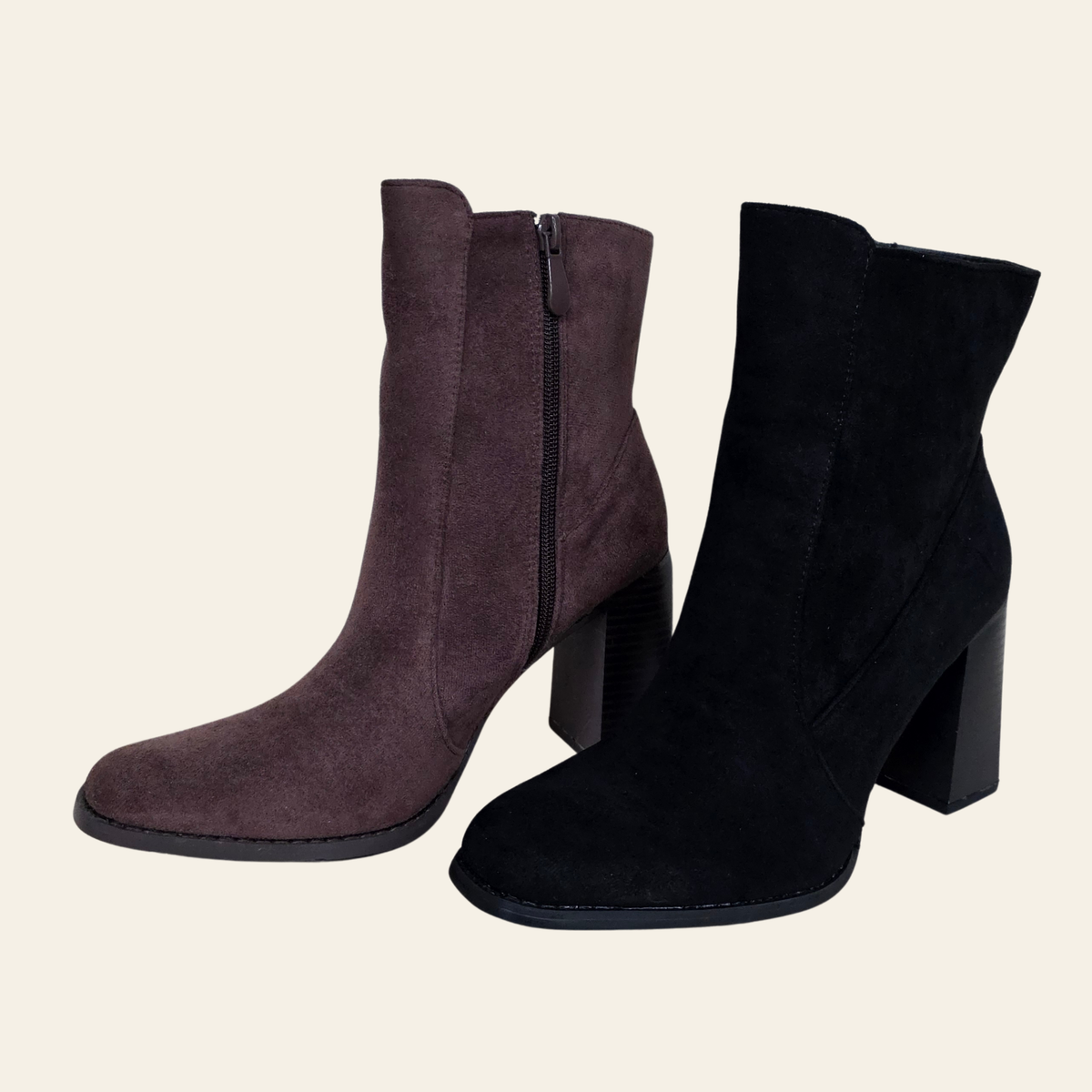 A pair of women's ankle boots in suede, one in dark brown and one in black, both featuring a block heel and side zipper, set against a solid light beige background.