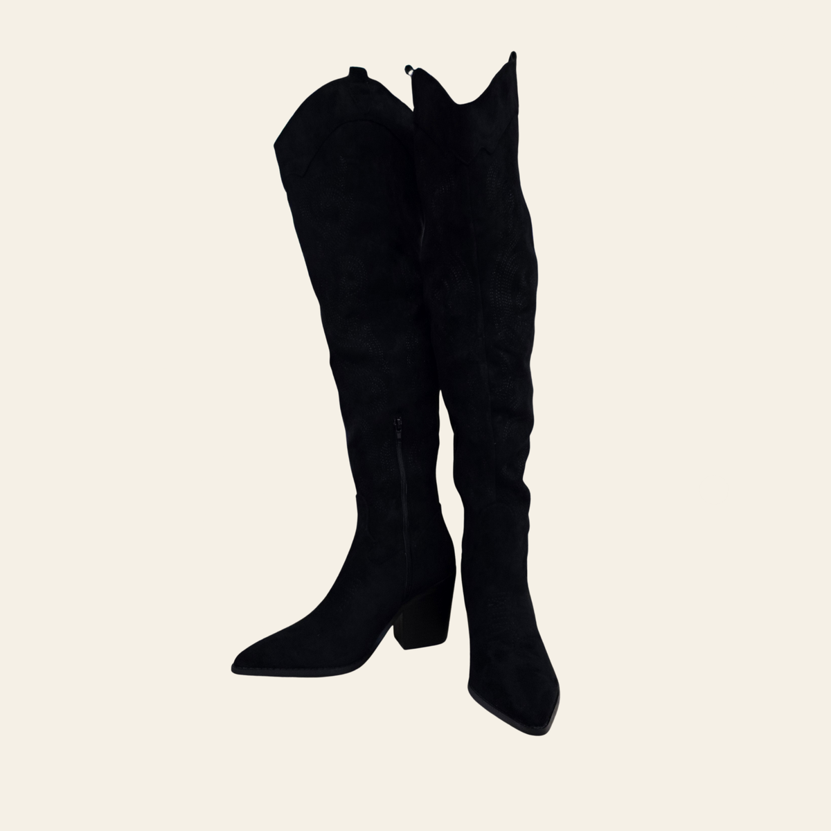 A pair of black suede over-the-knee boots with a pointed toe and block heel, shown against a solid light beige background.