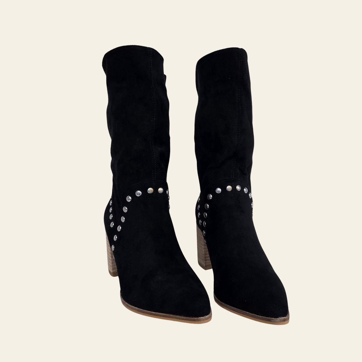 Front view of The Brigitta - a black faux suede slouchy boot with metal rivet embellishments, pointed toe and stacked heel.