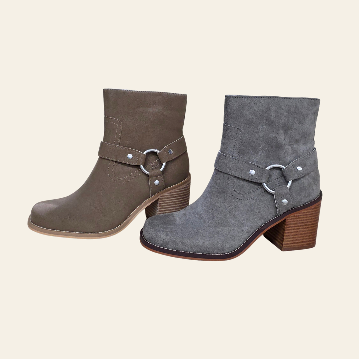 Two ankle boots with block heels and decorative buckle straps, shown on a plain light beige background. One boot is taupe-brown and the other is gray suede.