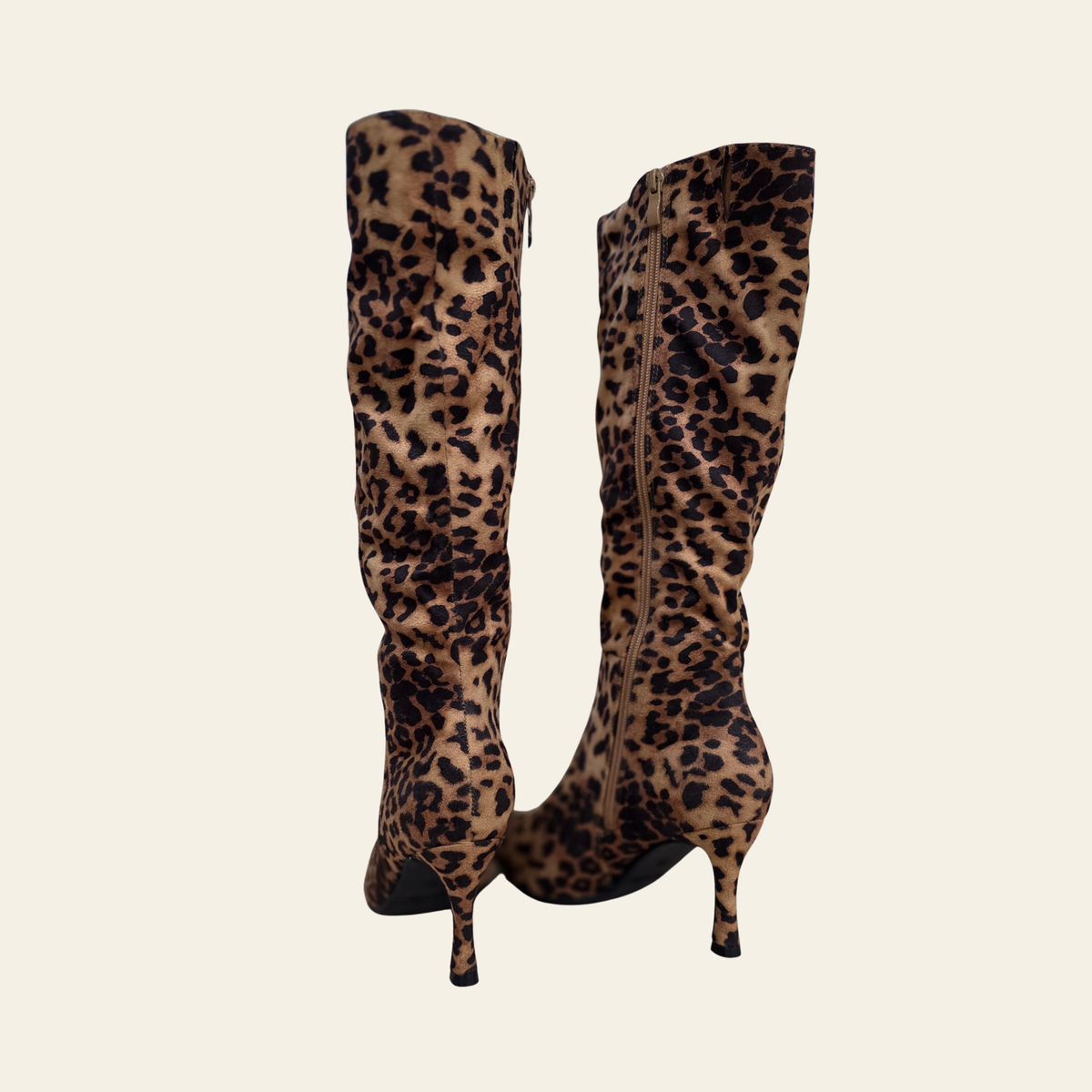 Back view of leopard print knee-high boots with mid heel