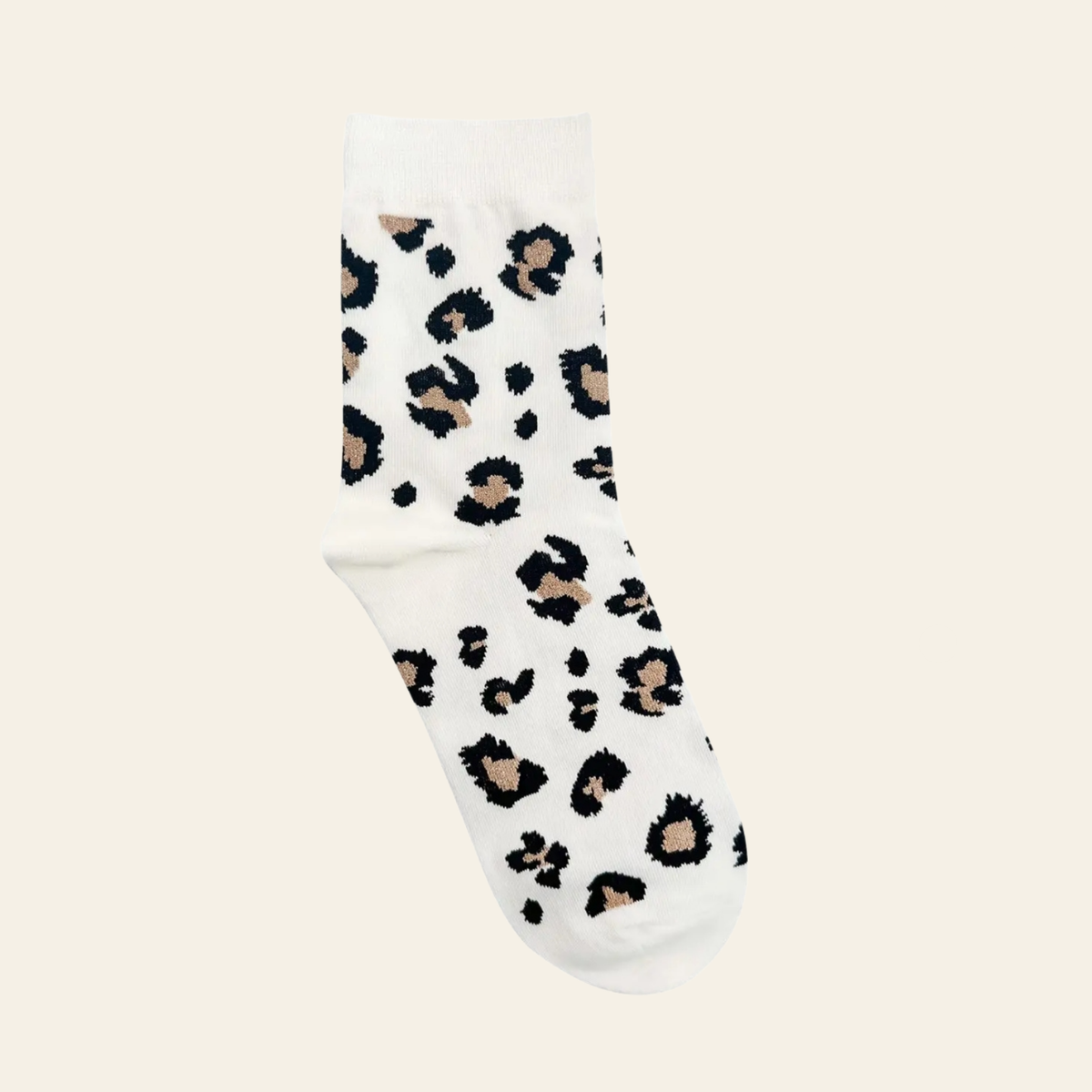 A single cream crew sock with an all-over leopard print pattern in black and beige, shown against a solid light cream background.