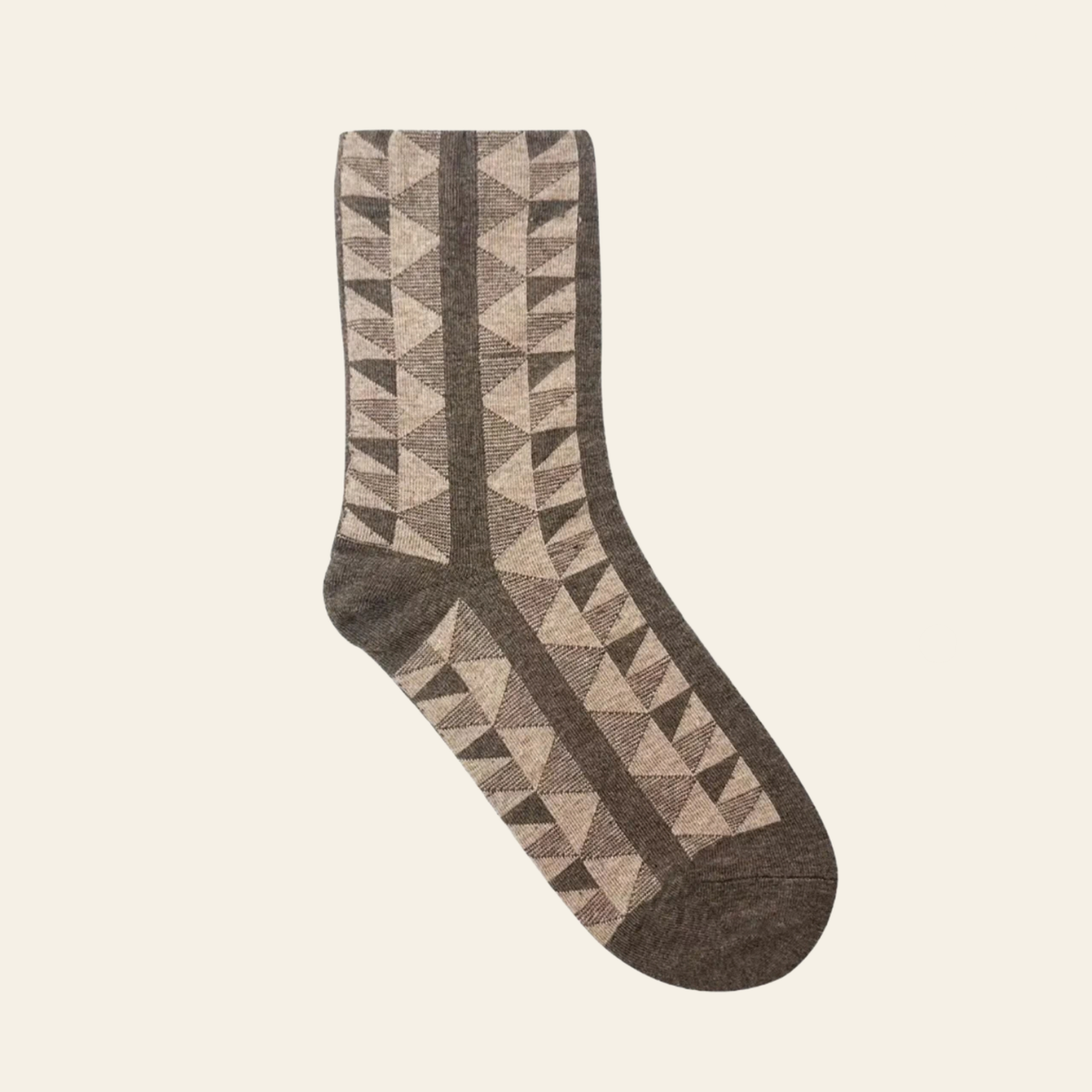 A single crew sock with a geometric triangle pattern in shades of brown, taupe, and beige, shown against a solid off-white background.
