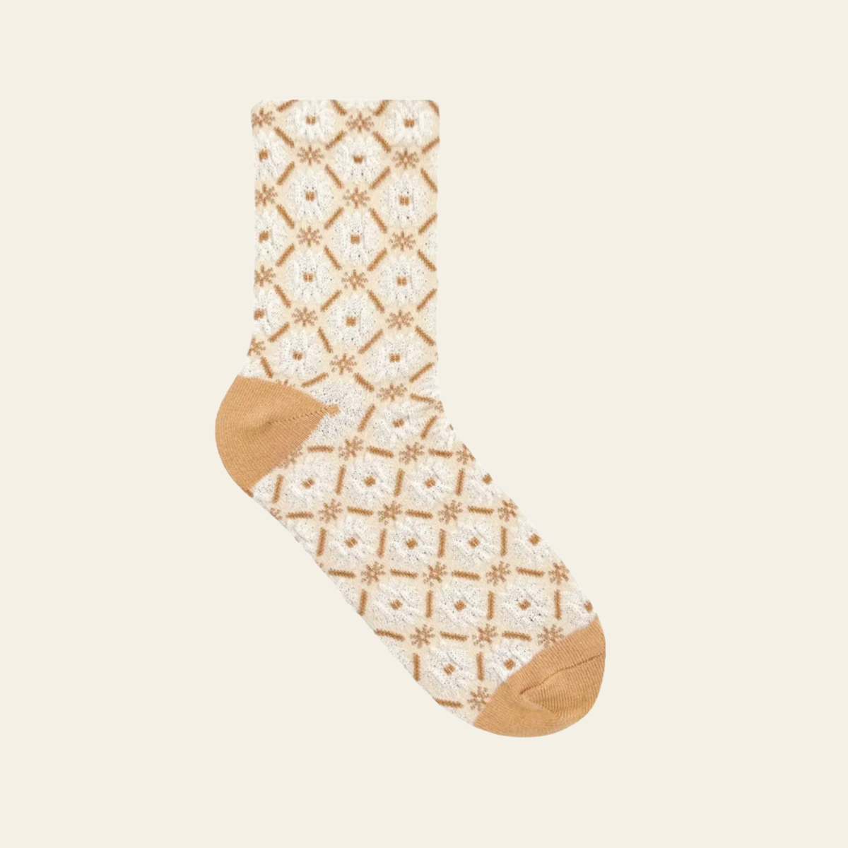 A single crew sock with a cream and tan geometric lattice pattern, featuring solid tan heels, toes, and cuffs, displayed against a solid cream background.