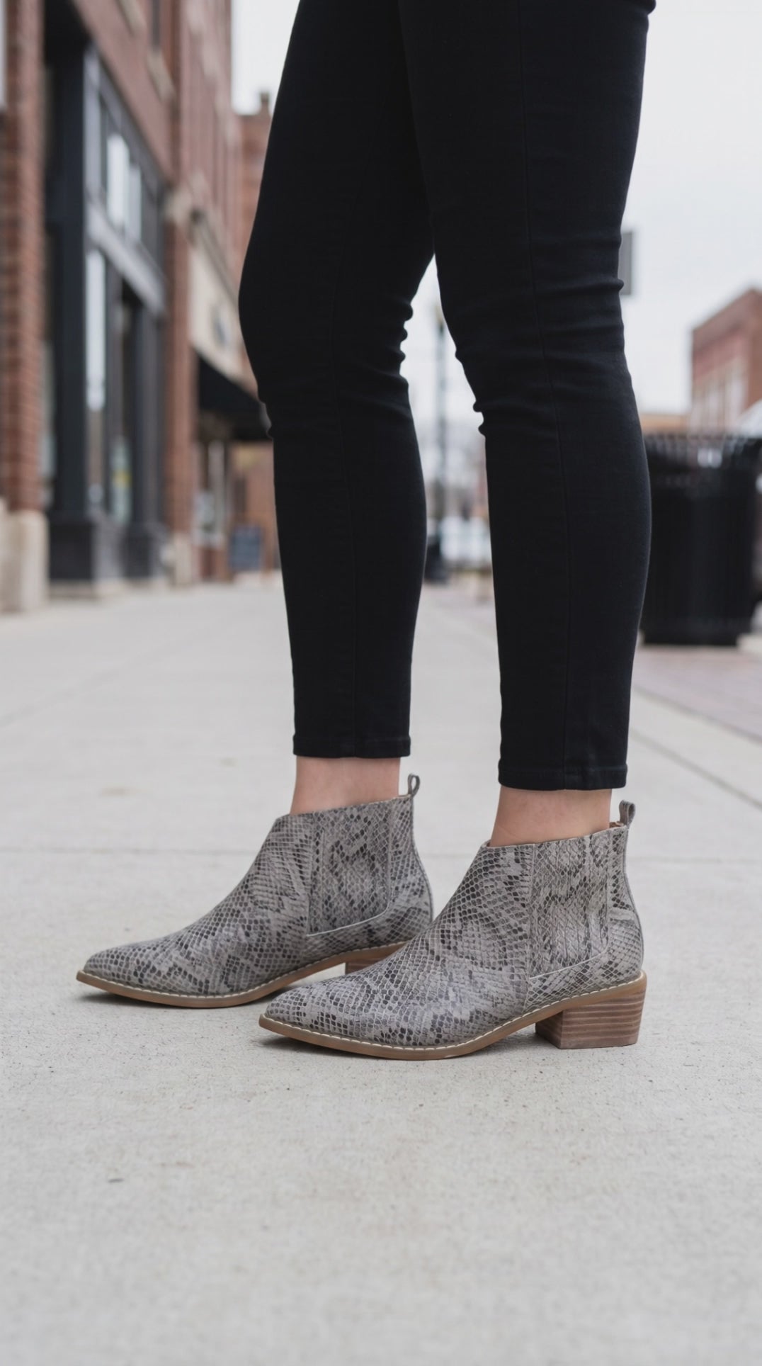 Model wearing Trinity Snake-skin patterned booties