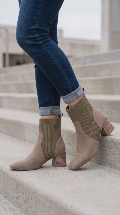 Model on steps wearing the Geraldine Sock Boot in taupe