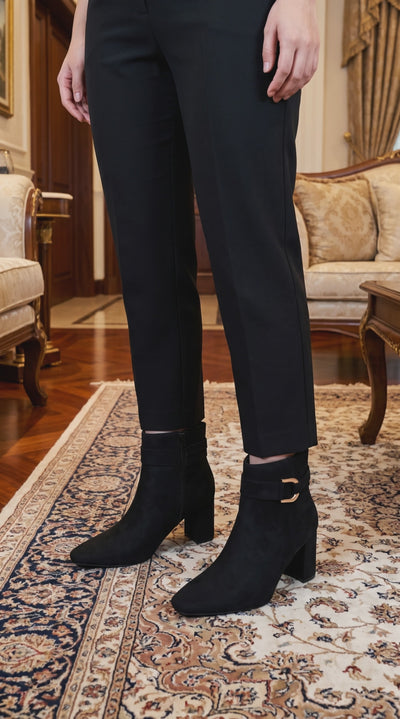 Model wearing Soda Novela Boots walking across the living room